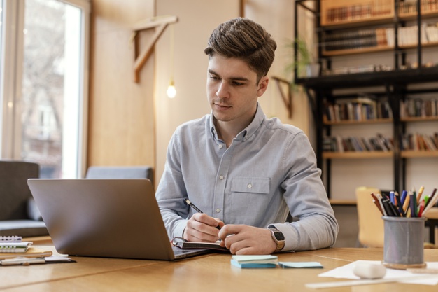 portrait-man-working-laptop_23-2148898741